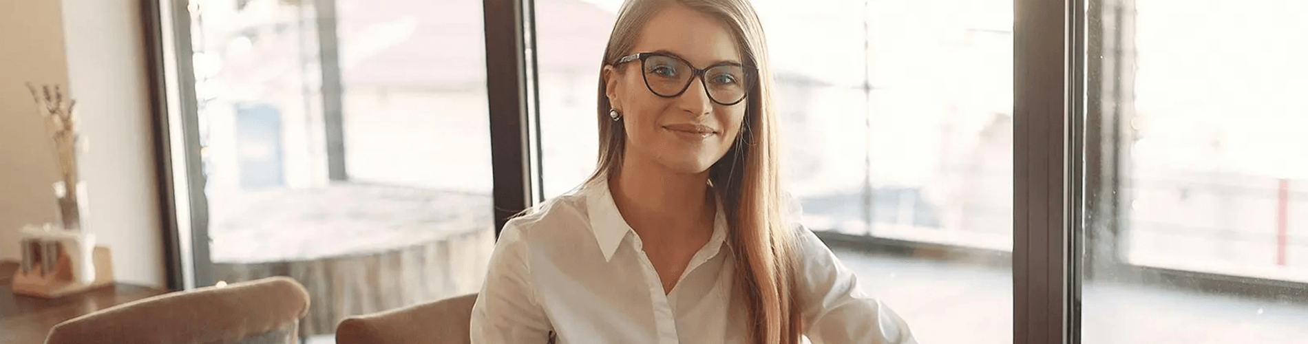 smiling woman sitting at her desk