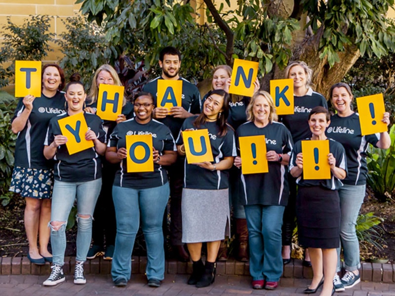 Lifeline workers holding up a thank you sign as individual letters
