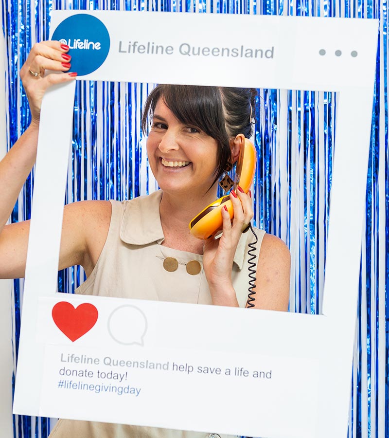 A woman posing with a social media cut-out