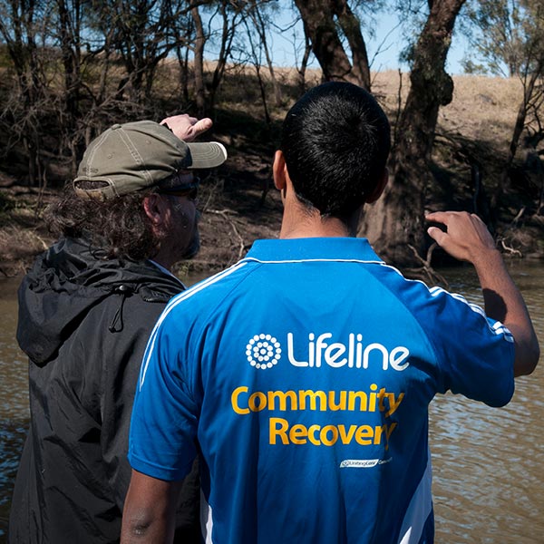 A lifeline community recovery worker and a man at a river