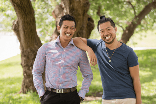 2 men laughing under a tree